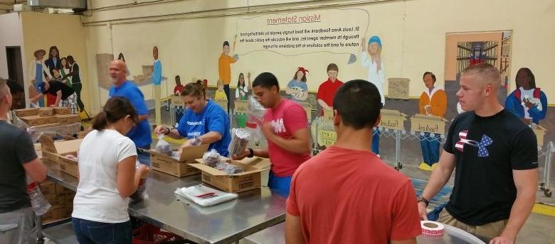 Volunteers package food for distribution at the St. Louis Area Foodbank.